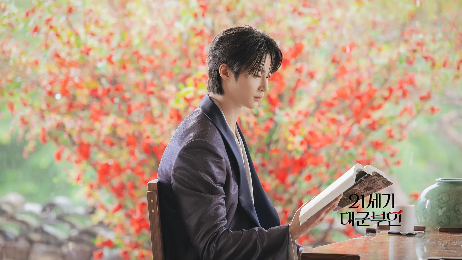 Prince I-an reading under autumn leaves at a traditional pavilion